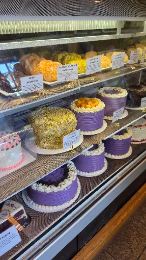 Purple frosted cakes in a case
